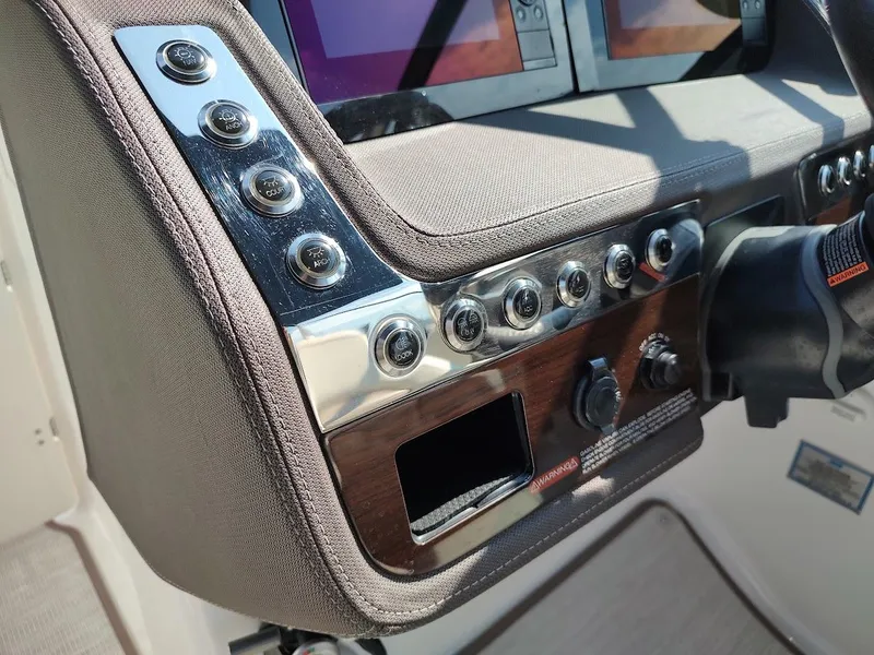 Slide: The Image of Control panel of a 2018 Chaparral 267 SSX boat with buttons and screens. - 33