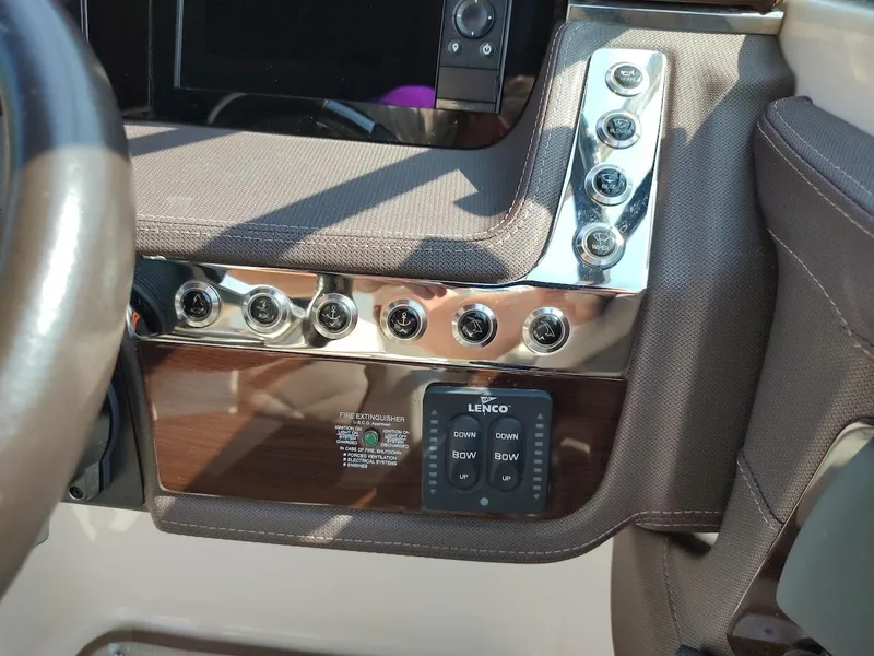 Slide: The Image of Control panel of 2018 Chaparral 267 SSX boat with buttons and Lenco trim tab switches. - 34
