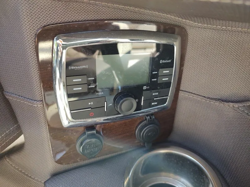 Slide: The Image of Control panel of a 2018 Chaparral 267 SSX boat with audio system and cup holder. - 35