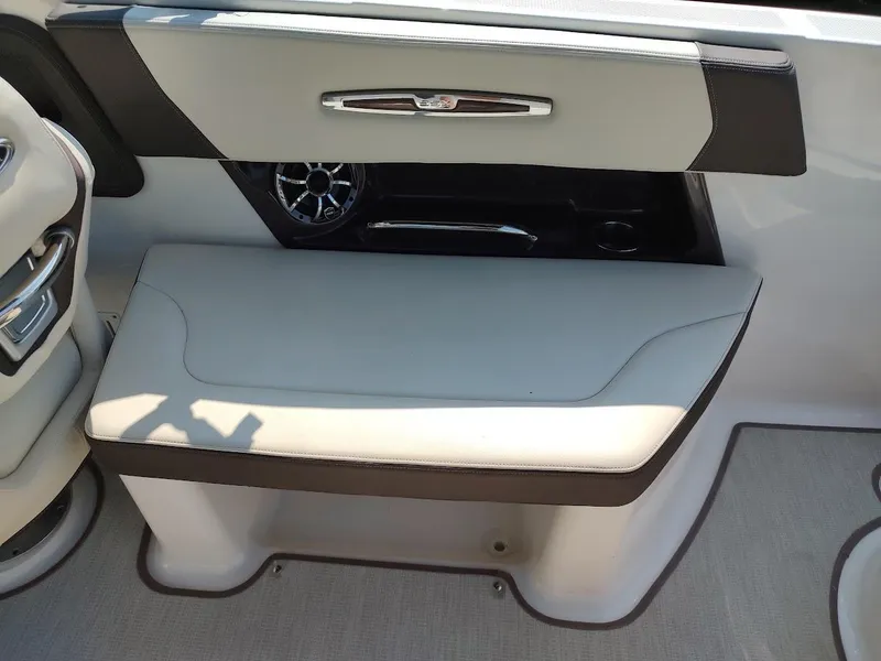 Slide: The Image of 2018 Chaparral 267 SSX boat interior with cushioned seating and speaker detail. - 42