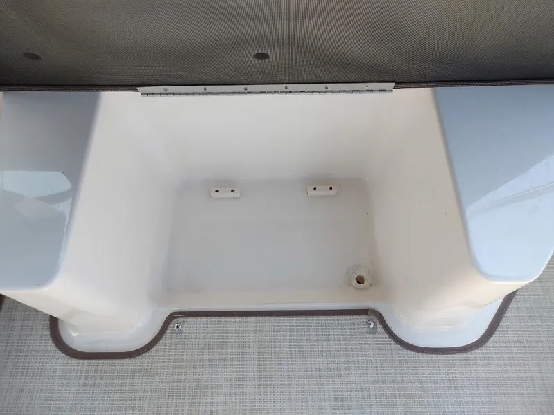 Slide: The Image of Storage compartment of 2018 Chaparral 267 SSX boat, featuring a clean, white interior. - 43