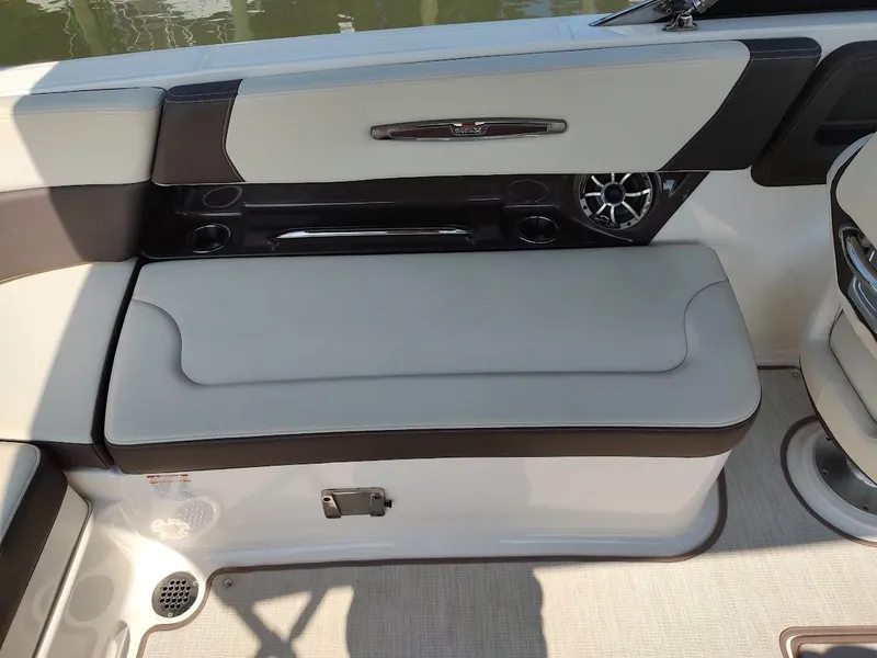 Slide: The Image of 2018 Chaparral 267 SSX boat interior with cushioned seating and speaker system. - 44
