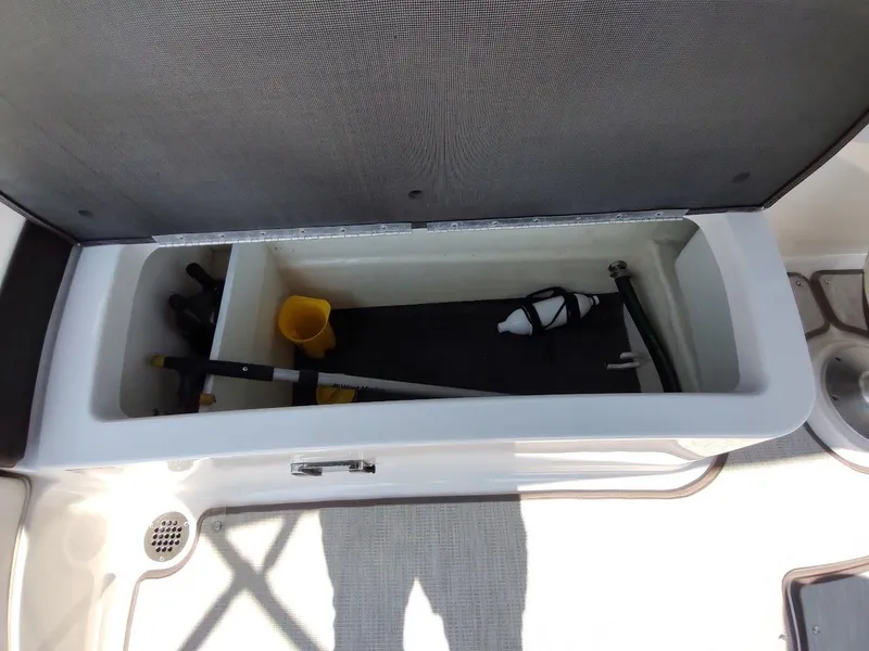 Slide: The Image of Storage compartment in 2018 Chaparral 267 SSX boat, containing boating equipment and accessories. - 45