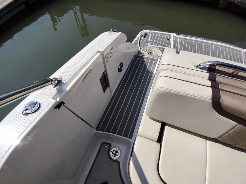 Slide: The Image of 2018 Chaparral 267 SSX boat interior with beige seating and sleek deck design. - 49