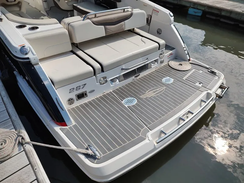 Slide: The Image of 2018 Chaparral 267 SSX boat with spacious rear deck and seating at dock. - 5