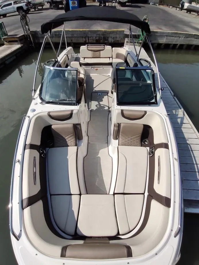 Slide: The Image of 2018 Chaparral 267 SSX boat with spacious seating, docked at marina. - 7