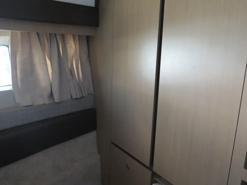 Slide: The Image of Interior cabin of 2017 Sea Ray 400 Sundancer yacht with wooden cabinets. - 15