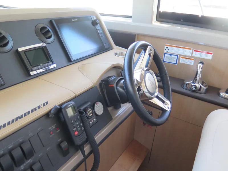 Slide: The Image of Helm of 2017 Sea Ray 400 Sundancer with navigation equipment and controls. - 17