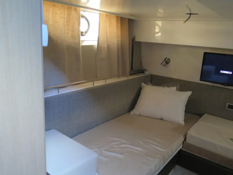 Slide: The Image of Interior cabin of 2017 Sea Ray 400 Sundancer yacht with bed and window. - 8