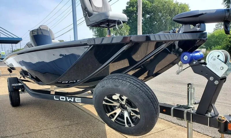 Slide: The Image of 2024 Lowe Stinger 175 boat on trailer, side view, black exterior. - 12