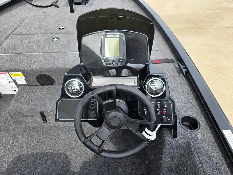 Slide: The Image of 2024 Lowe Stinger 175C boat dashboard with steering wheel and navigation system. - 13