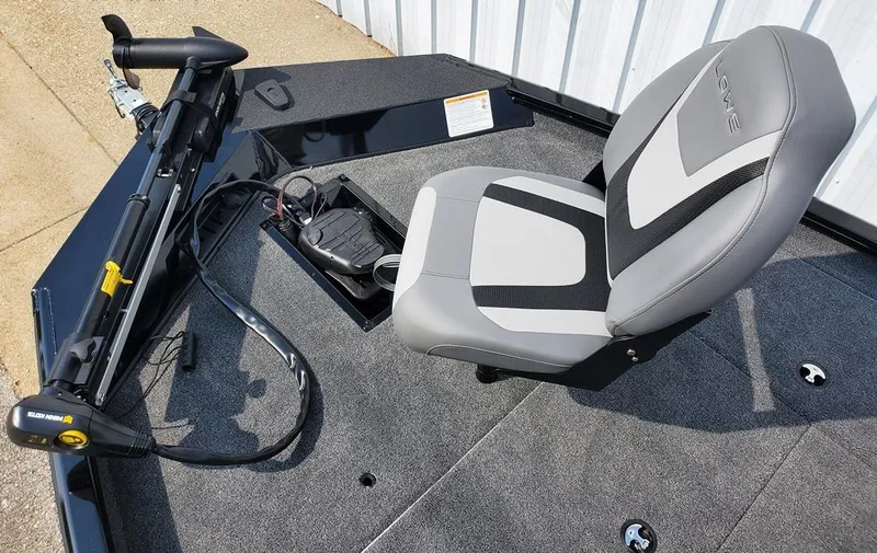 Slide: The Image of 2024 Lowe Stinger 175 boat with a comfortable seat and trolling motor. - 5
