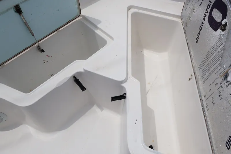 Slide: The Image of Interior of a 2010 Sea Hunt 24 Gamefish boat with storage compartments. - 13