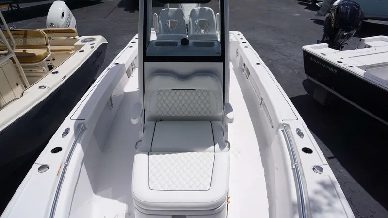 Slide: The Image of 2024 Sportsman 267 Masters OE boat interior with white cushioned seating. - 10
