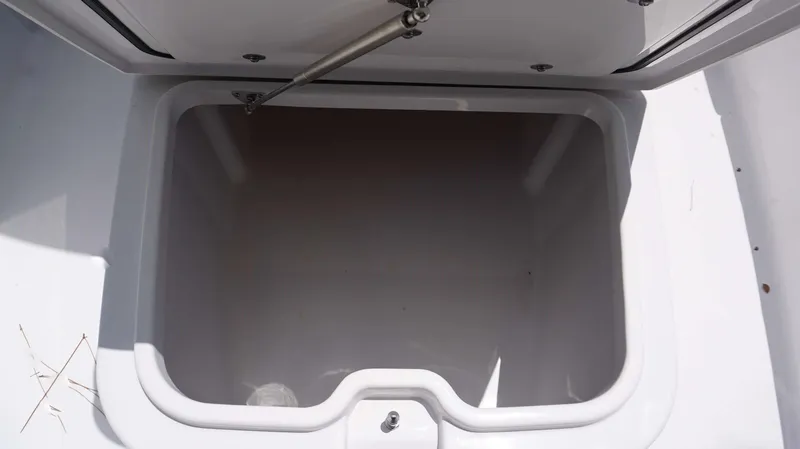 Slide: The Image of Open storage compartment of 2024 Sportsman 267 Masters OE boat. - 12