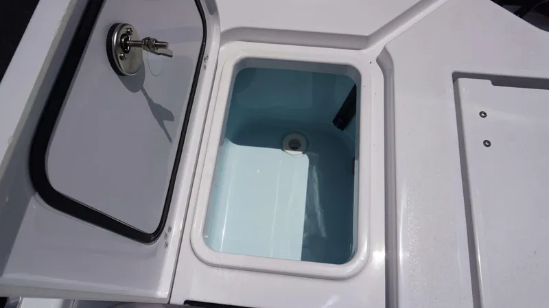 Slide: The Image of 2024 Sportsman 267 Masters OE livewell compartment with open lid. - 4