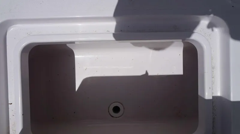 Slide: The Image of 2024 Sportsman 267 Masters OE boat storage compartment with drain. - 5