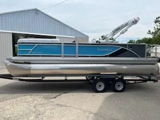 Slide: The Image of 2024 Sweetwater 2286SFL pontoon boat on a trailer outside a storage building. - 0