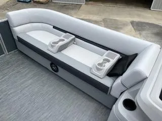 Slide: The Image of 2024 Sweetwater 2286SFL boat interior with white and gray seating and cup holders. - 10