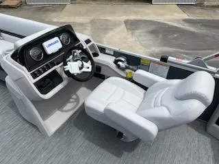 Slide: The Image of 2024 Sweetwater 2286SFL boat cockpit with steering wheel and control panel. - 11