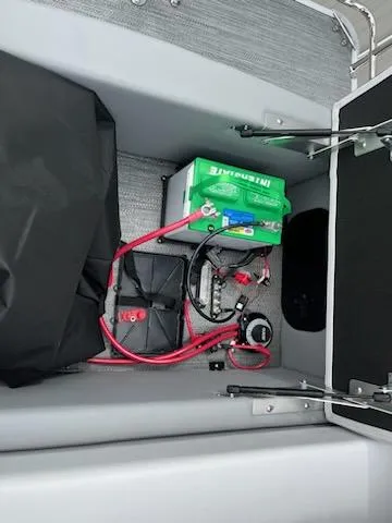 Slide: The Image of Battery compartment of 2024 Sweetwater 2286SFL boat with wiring and components. - 12