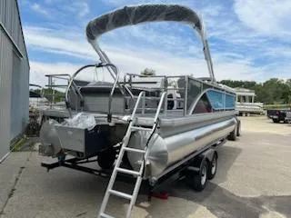 Slide: The Image of 2024 Sweetwater 2286SFL pontoon boat with ladder and canopy on trailer. - 3