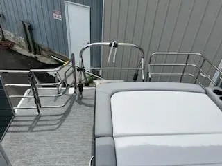 Slide: The Image of 2024 Sweetwater 2286SFL pontoon boat deck with railing and seating. - 5