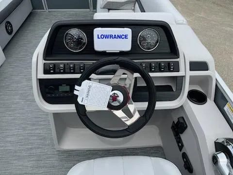 Slide: The Image of 2024 Sweetwater 2286SFL boat dashboard with Lowrance display and steering wheel. - 6