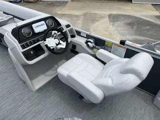 Slide: The Image of 2024 Sweetwater 2286SFL boat cockpit with steering wheel and captain's chair. - 7