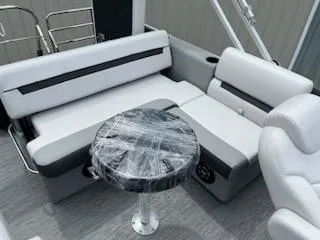 Slide: The Image of 2024 Sweetwater 2286SFL boat interior with white seating and wrapped table. - 8