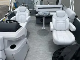 Slide: The Image of 2024 Sweetwater 2286SFL pontoon boat interior with white seating and table. - 9