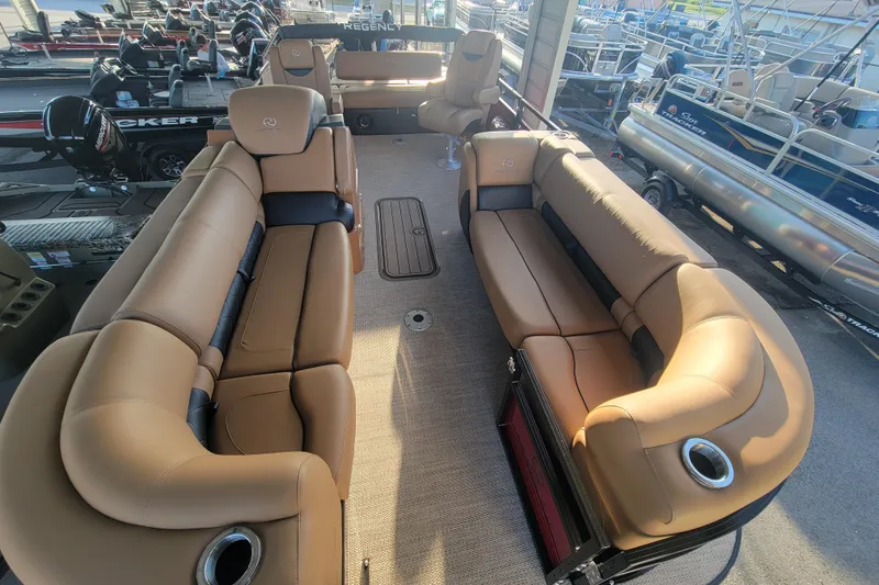 Slide: The Image of 2024 Regency 230 LE3 Sport pontoon boat with luxurious tan seating and spacious layout. - 2