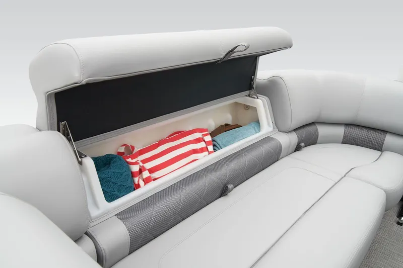 Slide: The Image of 2024 Regency 230 LE3 Sport boat storage compartment with towels and clothes. - 22