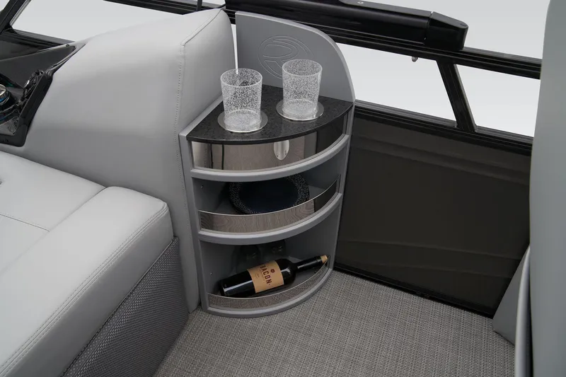 Slide: The Image of 2024 Regency 230 LE3 Sport boat interior with drink holders and storage shelves. - 41