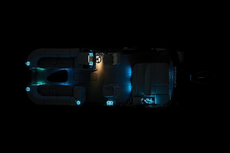 Slide: The Image of 2024 Regency 230 LE3 Sport pontoon boat with ambient blue lighting at night. - 50