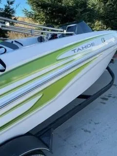 Slide: The Image of 2024 Tahoe T18 boat with green accents on a trailer. - 1