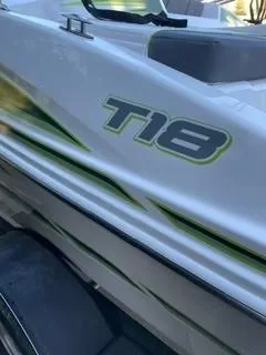 Slide: The Image of 2024 Tahoe T18 boat with sleek design and green accents. - 2