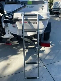Slide: The Image of 2024 Tahoe T18 boat with attached metal ladder on a sunny day. - 4