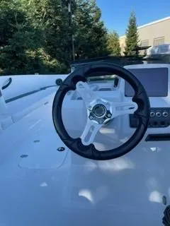 Slide: The Image of 2024 Tahoe T18 boat steering wheel and dashboard, outdoors. - 7