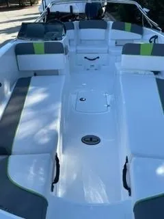Slide: The Image of 2024 Tahoe T18 boat interior with white and green seating. - 8