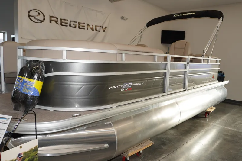 The Image of 2024 Sun Tracker Party Barge 22 XP3 pontoon boat displayed indoors. - 1