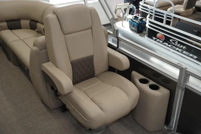 Slide: The Image of 2024 Sun Tracker Party Barge 22 XP3 interior with plush seating and cup holders. - 7