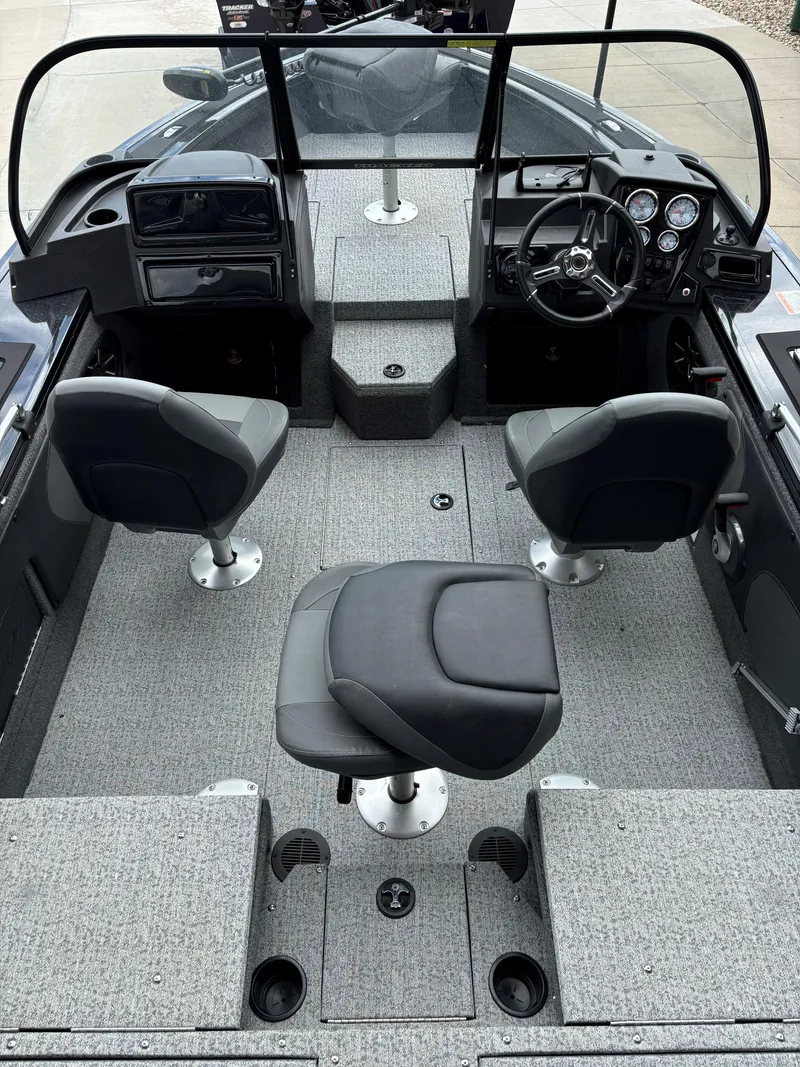 Slide: The Image of 2024 Tracker Targa V-19 Combo boat interior with seating and control console. - 3
