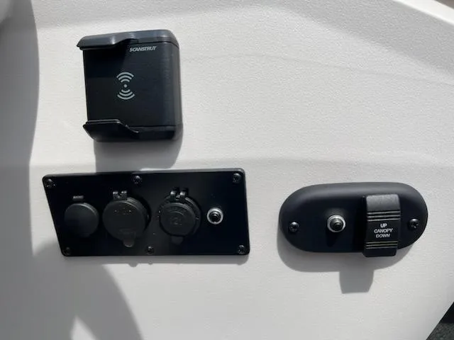 Slide: The Image of Control panel of 2024 Sweetwater 2286C boat with power outlets and canopy switch. - 11