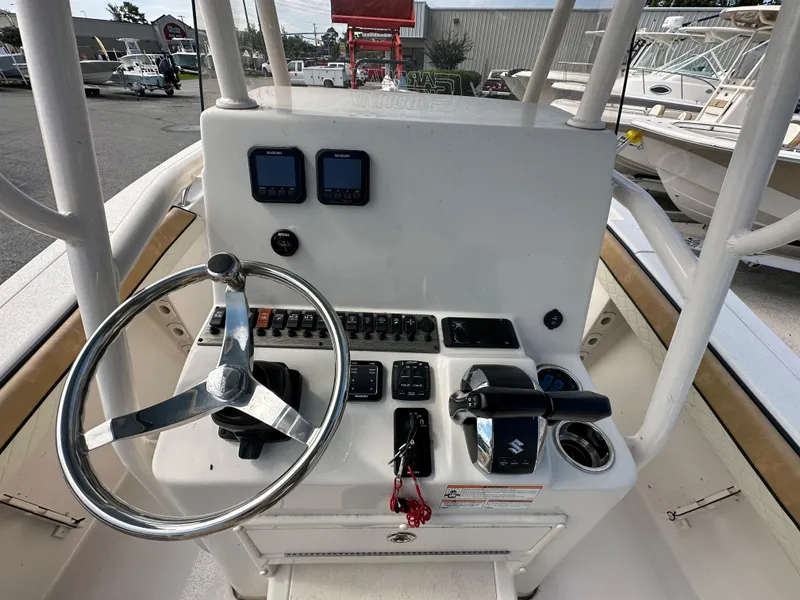 Slide: The Image of 2023 Sea Chaser 24 HFC boat console with steering wheel and control panel. - 10