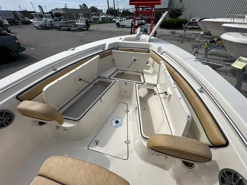 Slide: The Image of 2023 Sea Chaser 24 HFC boat with open storage compartments and seating. - 13