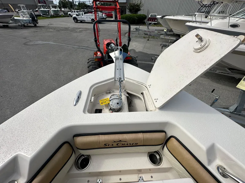 Slide: The Image of 2023 Sea Chaser 24 HFC boat with open anchor hatch, docked at marina. - 14