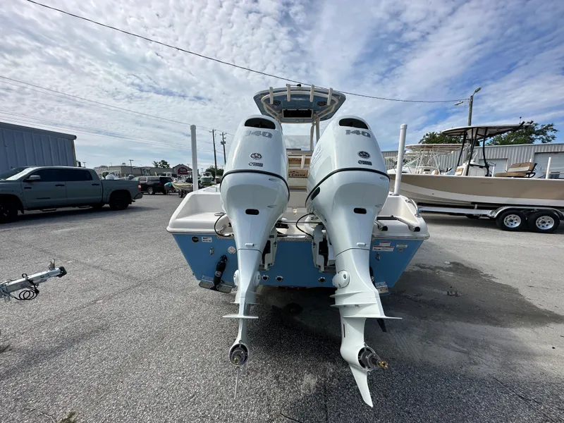 Slide: The Image of 2023 Sea Chaser 24 HFC boat with twin outboard engines, rear view. - 2