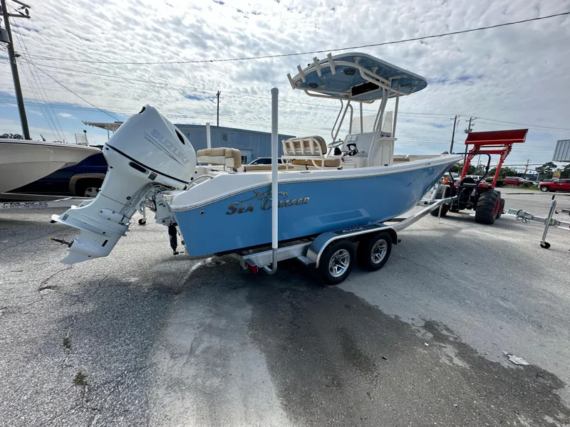 Slide: The Image of 2023 Sea Chaser 24 HFC boat on a trailer, featuring a powerful outboard motor. - 3