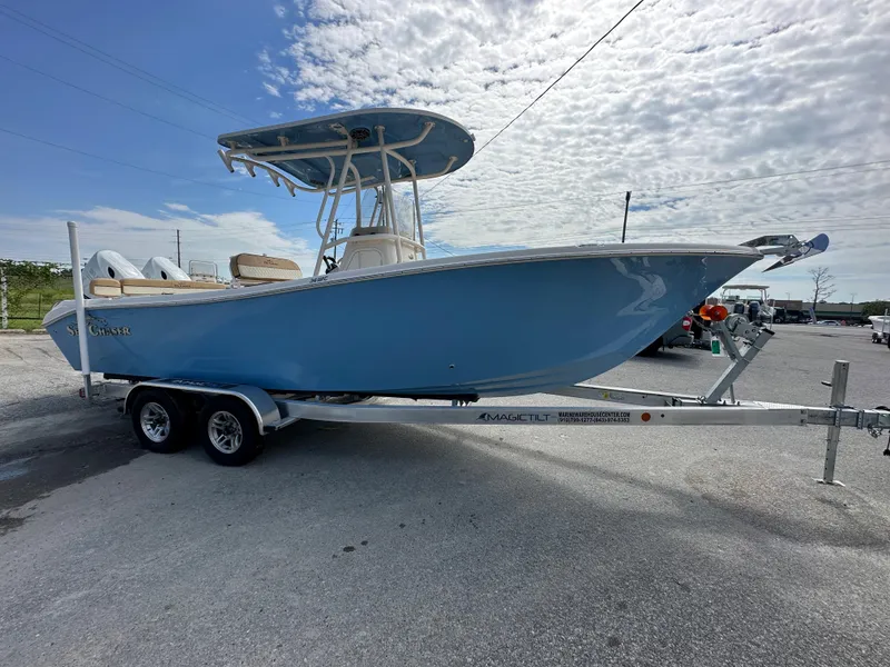 Slide: The Image of 2023 Sea Chaser 24 HFC boat on a trailer under a partly cloudy sky. - 4